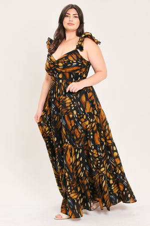 A woman modeling a floor-length tiered maxi dress with a black and orange butterfly wing print, featuring ruffled shoulder straps and a sweetheart neckline, set against a plain light gray studio background | Flying Tomato Curve