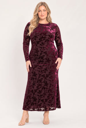 A woman modeling a long-sleeve, midi-length burgundy velvet dress with a tonal floral jacquard pattern | Flying Tomato