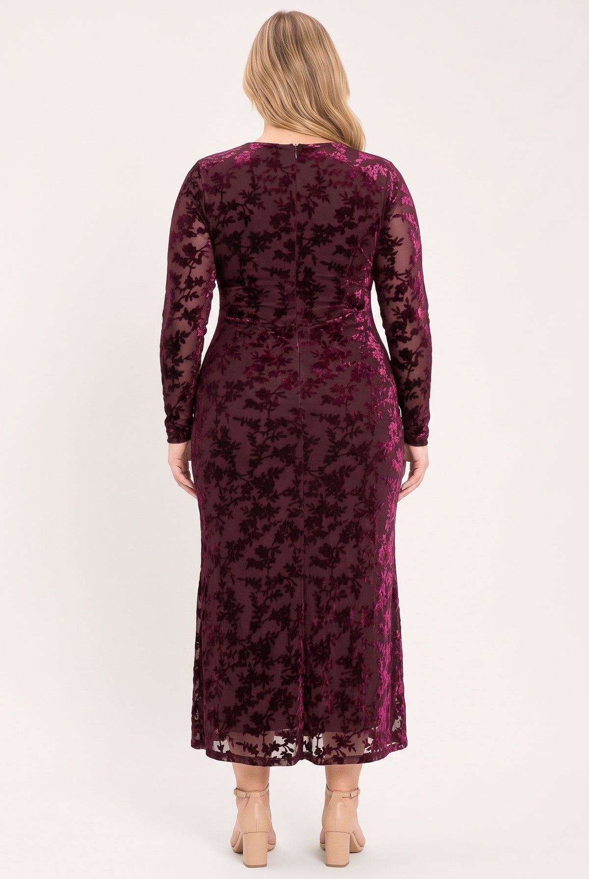 A woman modeling a long-sleeve, midi-length burgundy velvet dress with a tonal floral jacquard pattern | Flying Tomato
