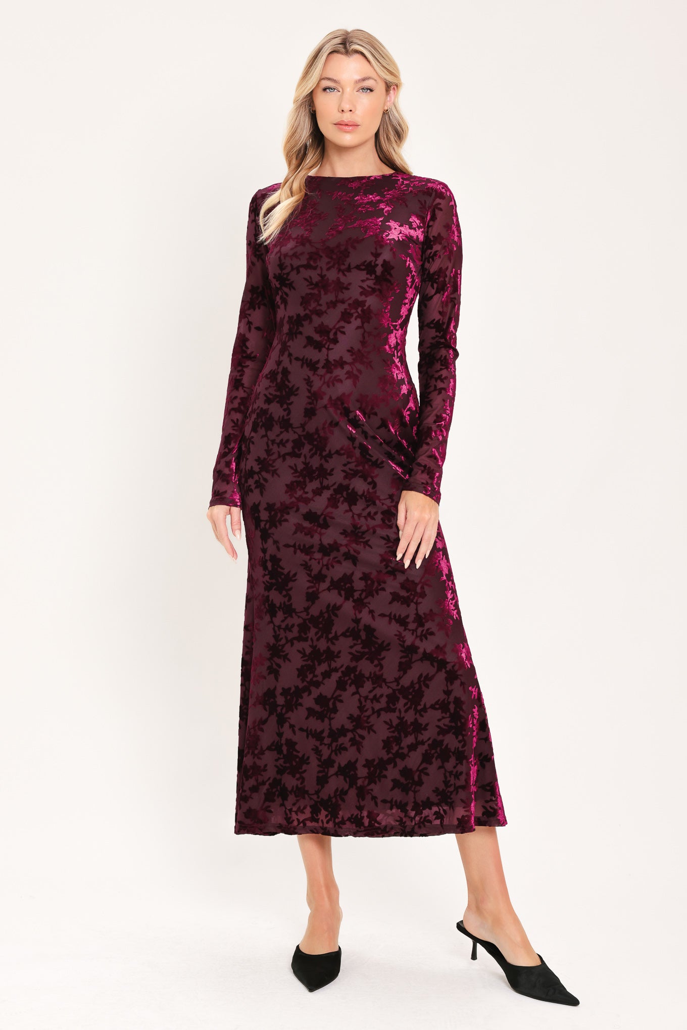 A woman modeling a long-sleeve, midi burgundy velvet dress with an allover tonal floral jacquard pattern | Flying Tomato