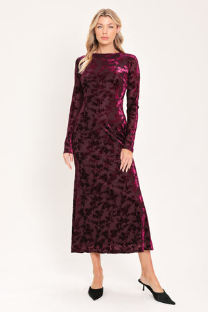 A woman modeling a long-sleeve, midi burgundy velvet dress with an allover tonal floral jacquard pattern | Flying Tomato