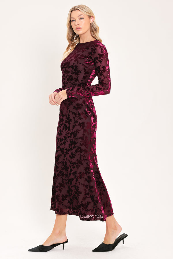 A woman modeling a long-sleeve, midi burgundy velvet dress with an allover tonal floral jacquard pattern | Flying Tomato