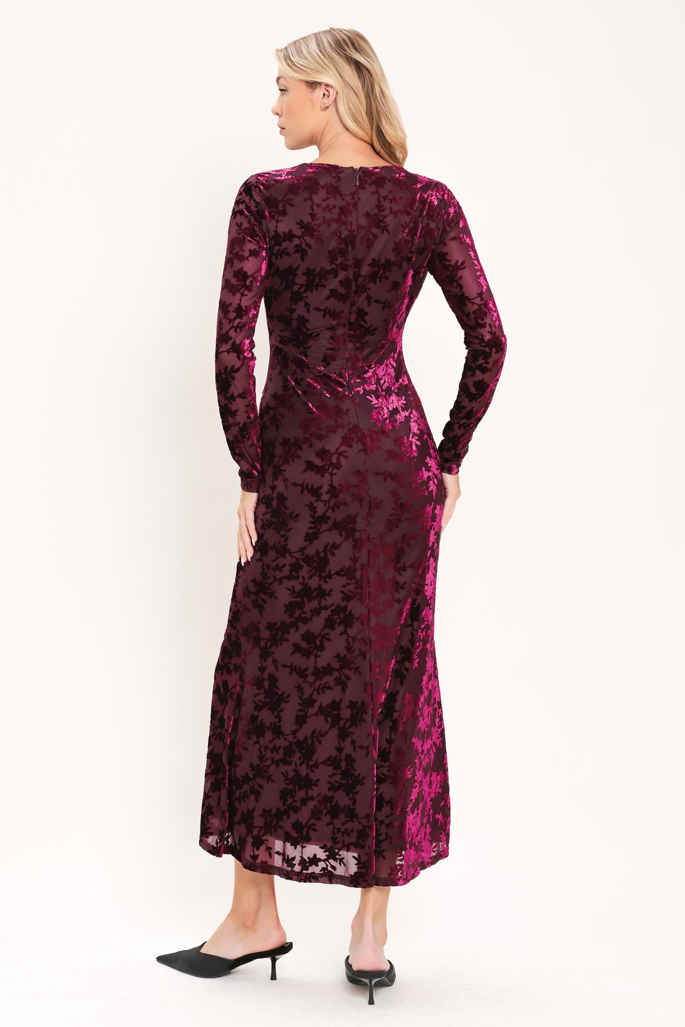 A woman modeling a long-sleeve, midi burgundy velvet dress with an allover tonal floral jacquard pattern | Flying Tomato