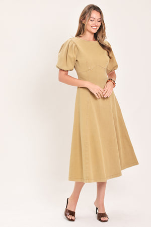A woman modeling a tan midi dress with puff sleeves, a round neckline, and a flared skirt | Flying Tomato