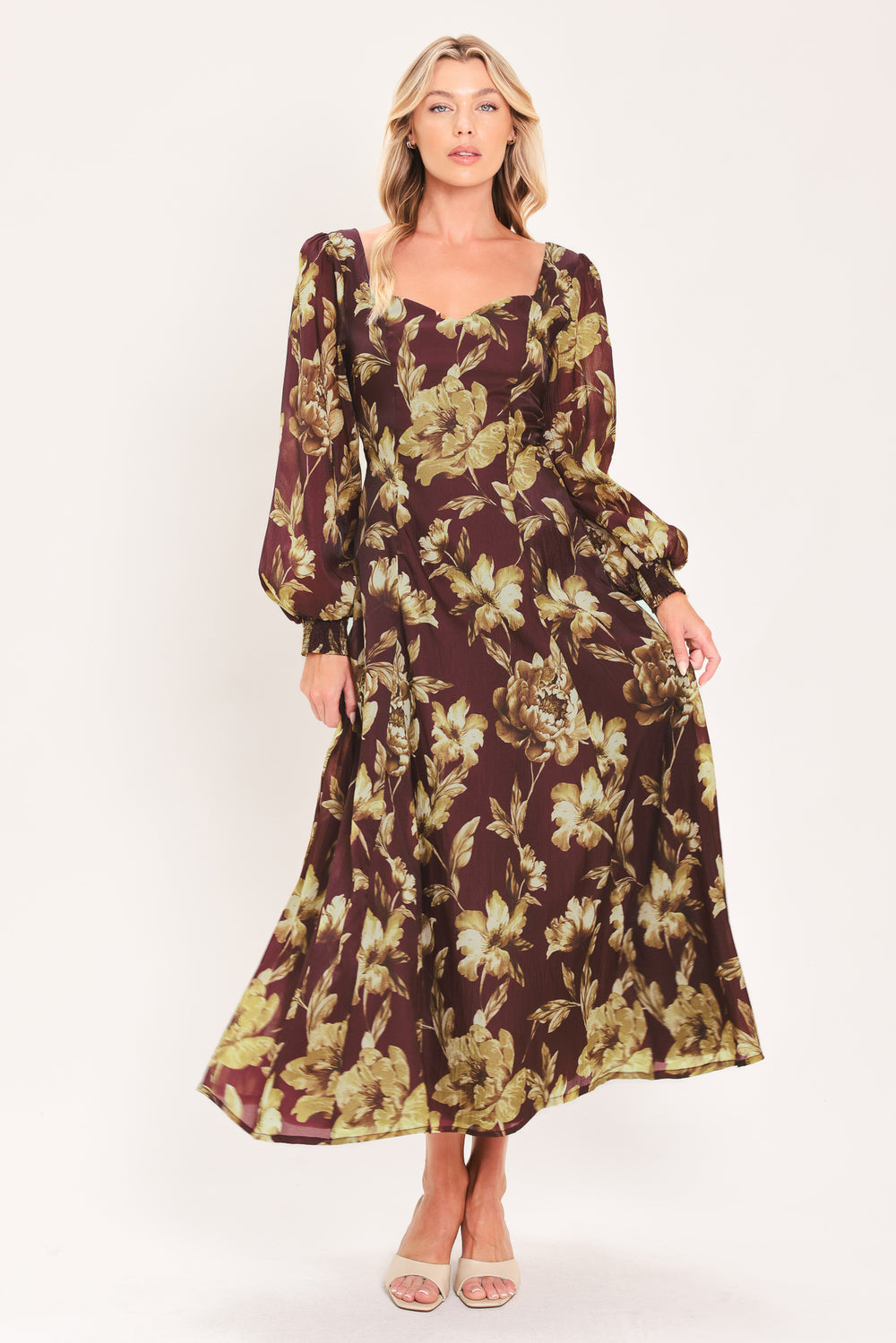 A woman modeling a long-sleeved midi dress with a burgundy and olive green floral pattern | Flying Tomato