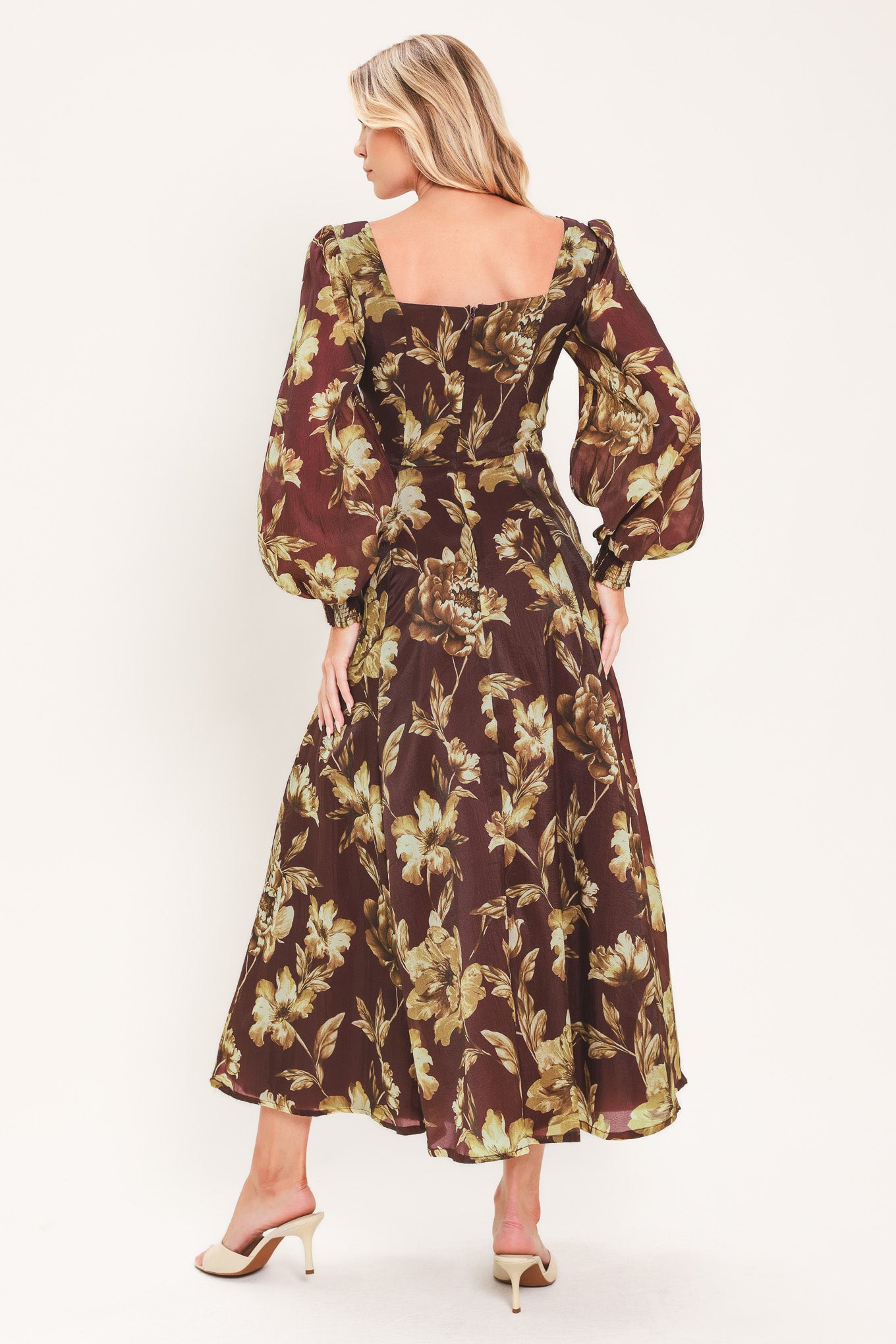A woman modeling a long-sleeved midi dress with a burgundy and olive green floral pattern | Flying Tomato