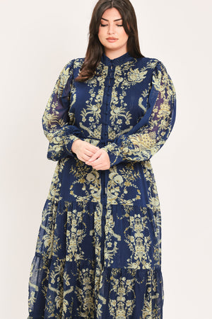 A woman modeling a long-sleeved navy blue maxi dress with a taupe toile floral pattern | Flying Tomato Curve