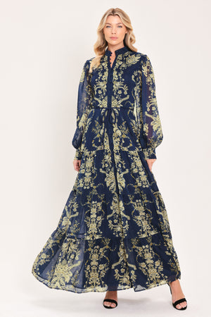 A woman modeling a long-sleeved navy blue maxi dress with a taupe toile floral pattern | Flying Tomato