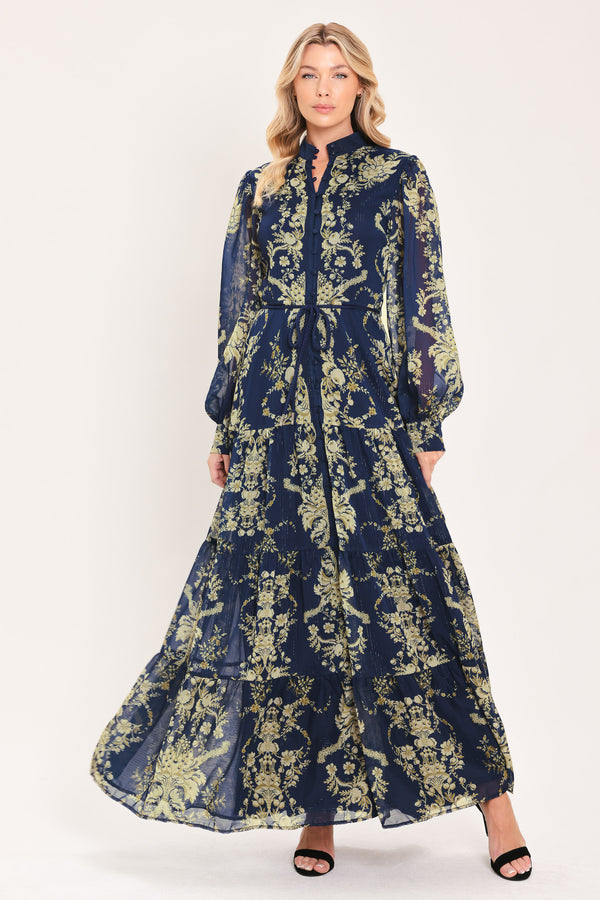 A woman modeling a long-sleeved navy blue maxi dress with a taupe toile floral pattern | Flying Tomato