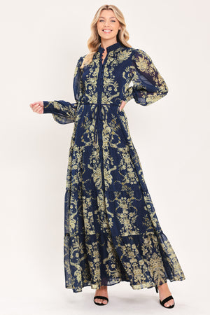 A woman modeling a long-sleeved navy blue maxi dress with a taupe toile floral pattern | Flying Tomato