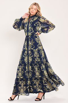 A woman modeling a long-sleeved navy blue maxi dress with a taupe toile floral pattern | Flying Tomato