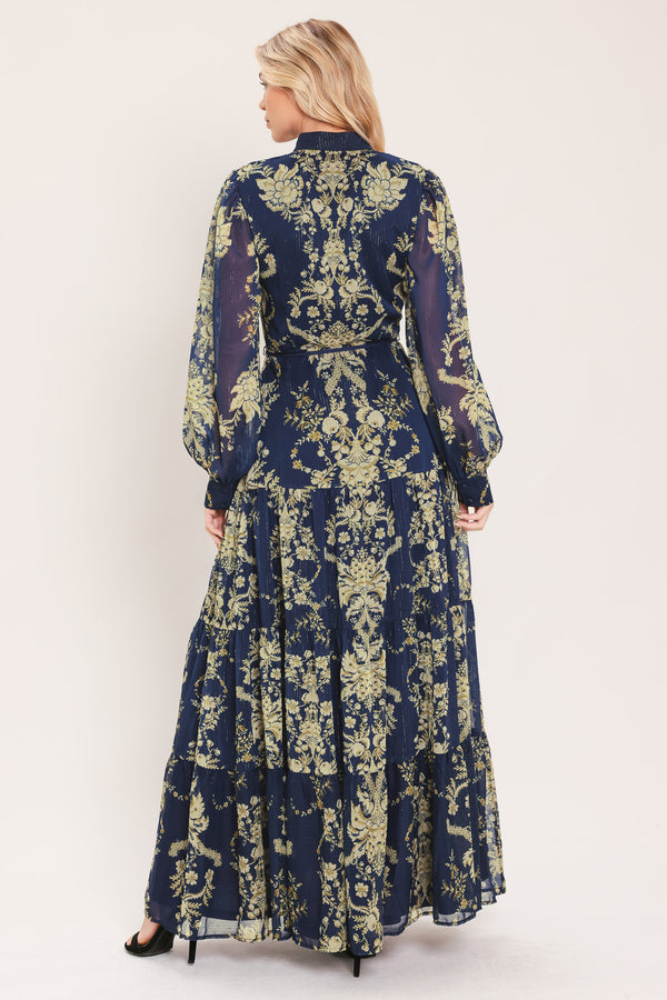 A woman modeling a long-sleeved navy blue maxi dress with a taupe toile floral pattern | Flying Tomato
