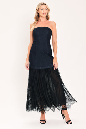 A woman modeling a strapless dark blue maxi dress with a fitted denim-like bodice and a flowing sheer tulle skirt with lace trim | Flying Tomato