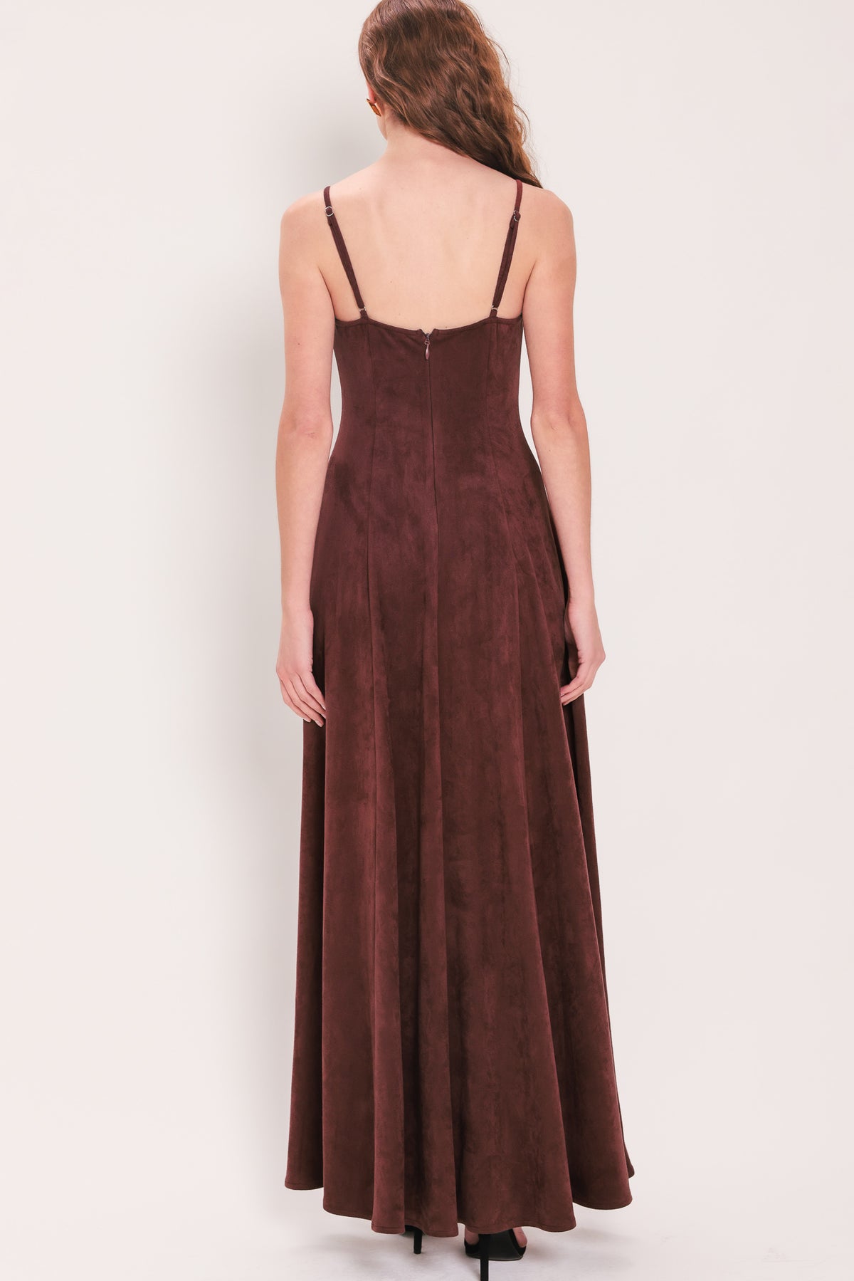 Woman wearing a sleeveless raisin brown suede maxi dress | Flying Tomato
