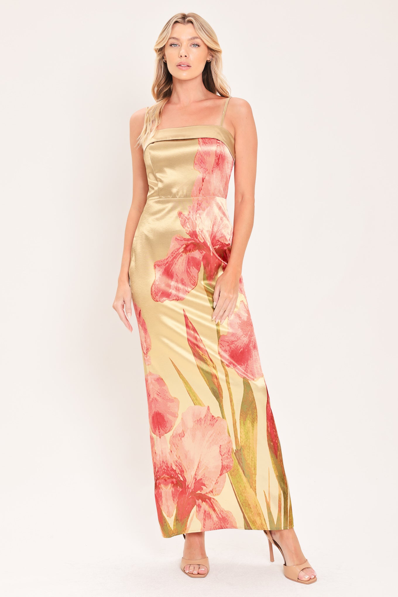 A woman modeling a maxi satin slip dress with a champagne gold base and a large pink floral print | Flying Tomato