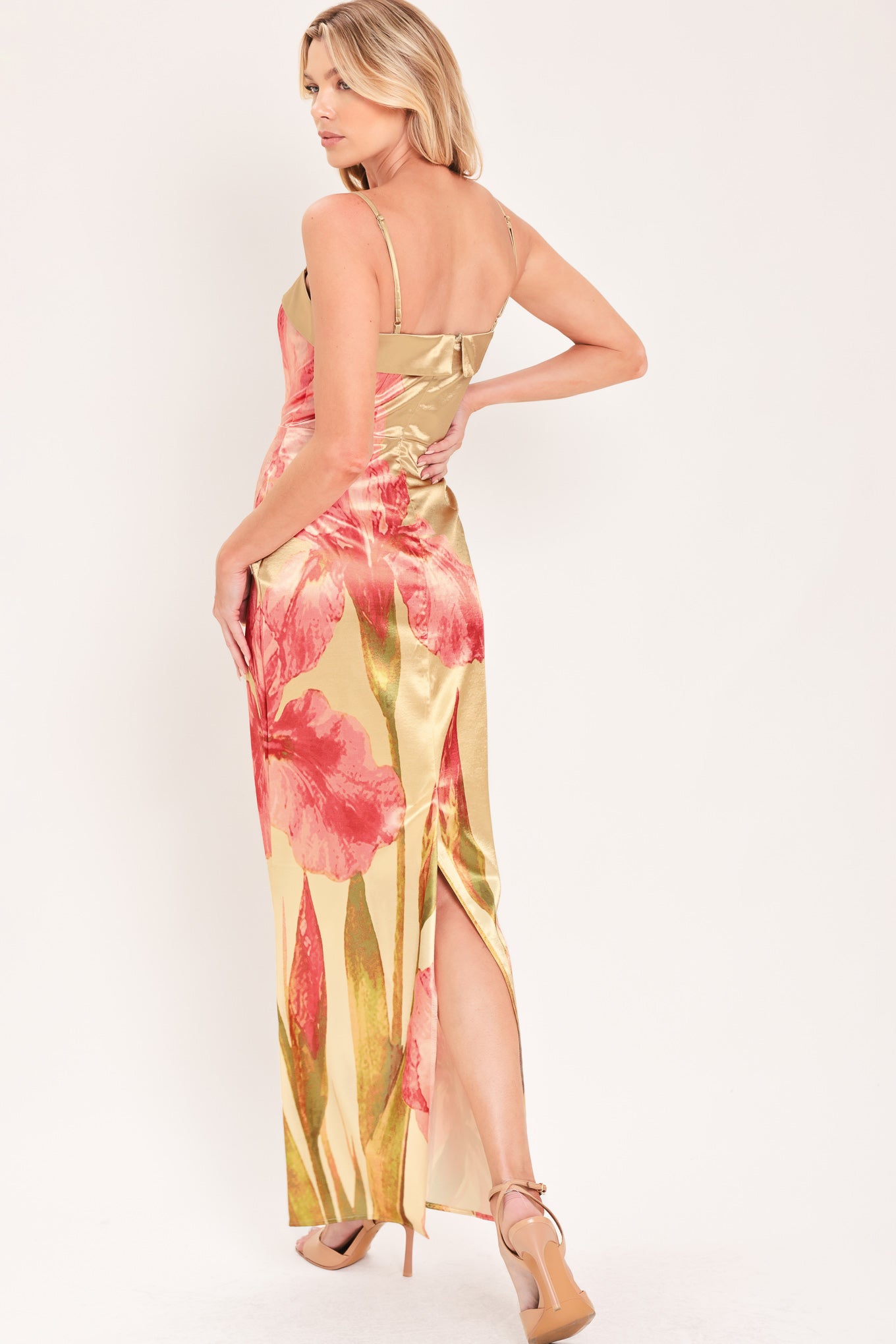 A woman modeling a maxi satin slip dress with a champagne gold base and a large pink floral print | Flying Tomato