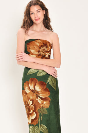 Woman wearing a strapless hunter green suede midi dress with giant rust orange flowers and leaves | Flying Tomato