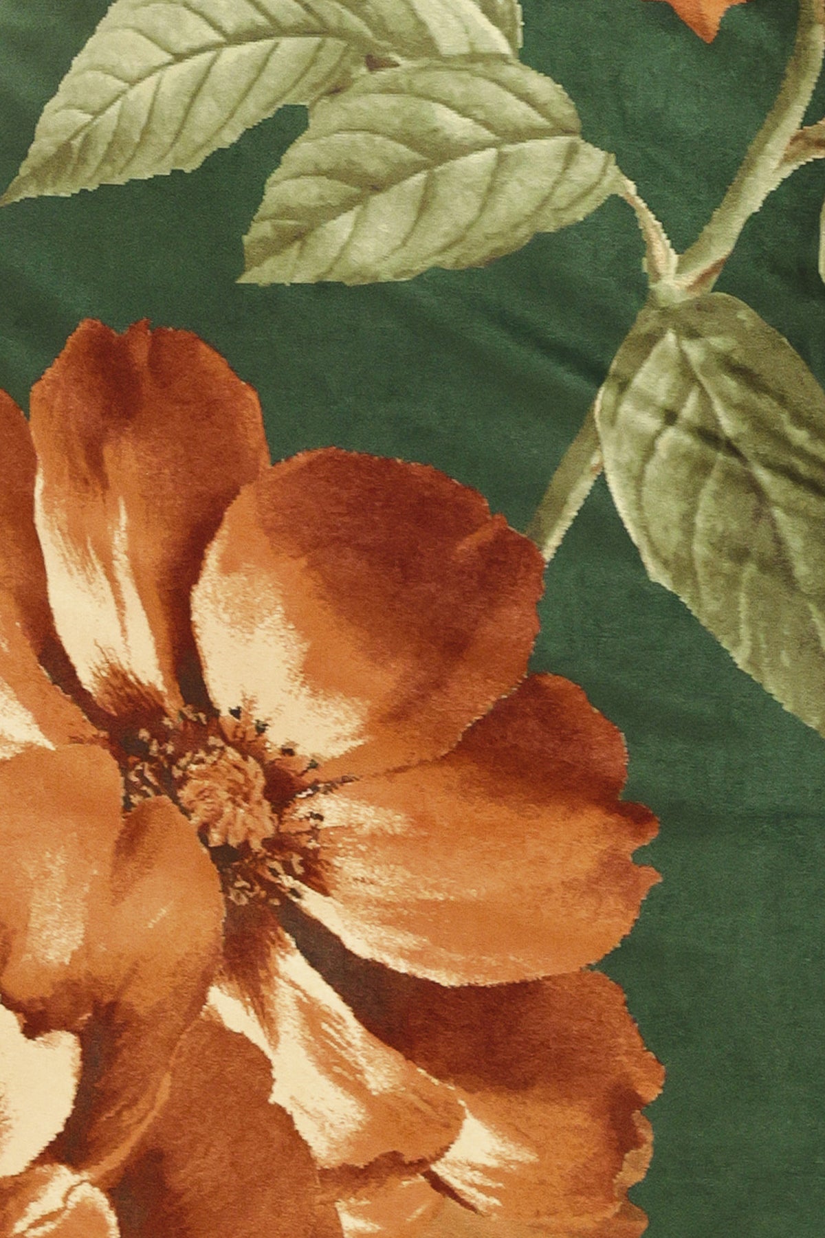 Woman wearing a strapless hunter green suede midi dress with giant rust orange flowers and leaves | Flying Tomato