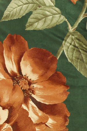 Woman wearing a strapless hunter green suede midi dress with giant rust orange flowers and leaves | Flying Tomato