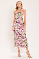 A woman modeling a sleeveless midi dress with thin straps and a ivory and mauve floral print | Flying Tomato