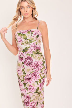 A woman modeling a sleeveless midi dress with thin straps and a ivory and mauve floral print | Flying Tomato