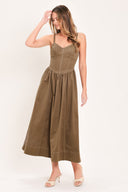 Woman wearing a cool tone brown sleeveless midi dress with bustier stitching details and princess cut waistline | Flying Tomato