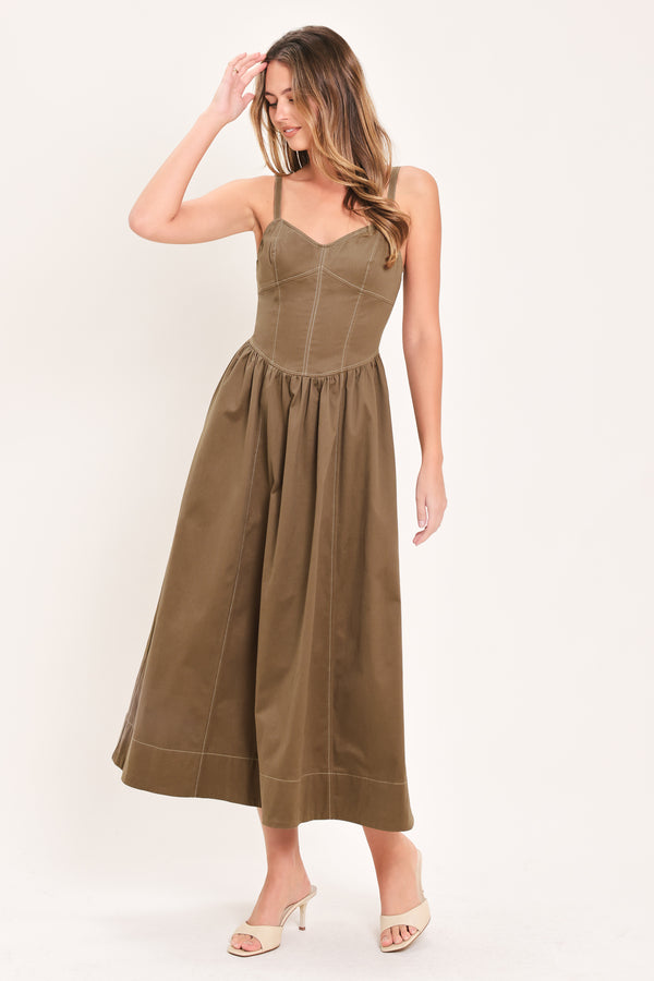 Woman wearing a cool tone brown sleeveless midi dress with bustier stitching details and princess cut waistline | Flying Tomato