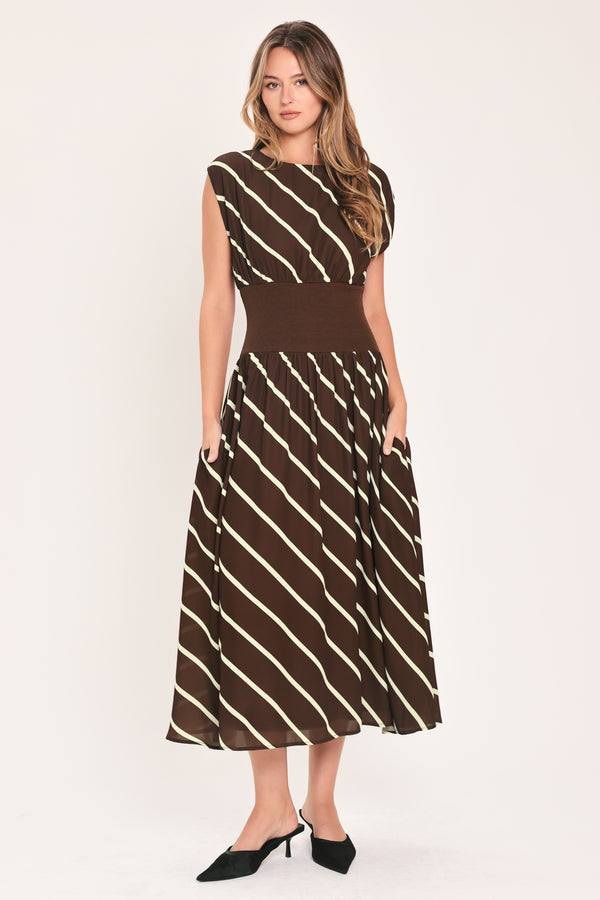 A woman modeling a sleeveless midi dress with a brown and cream diagonal striped pattern, featuring a defined waistband | Flying Tomato