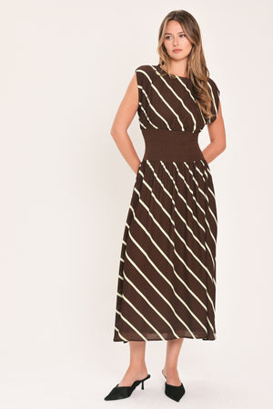 A woman modeling a sleeveless midi dress with a brown and cream diagonal striped pattern, featuring a defined waistband | Flying Tomato