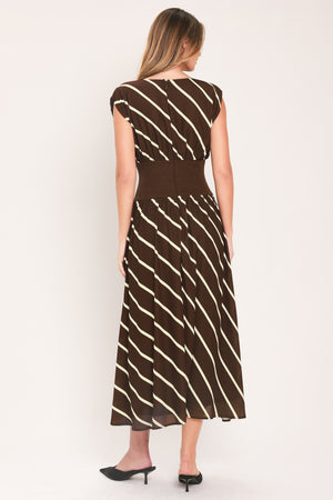 A woman modeling a sleeveless midi dress with a brown and cream diagonal striped pattern, featuring a defined waistband | Flying Tomato
