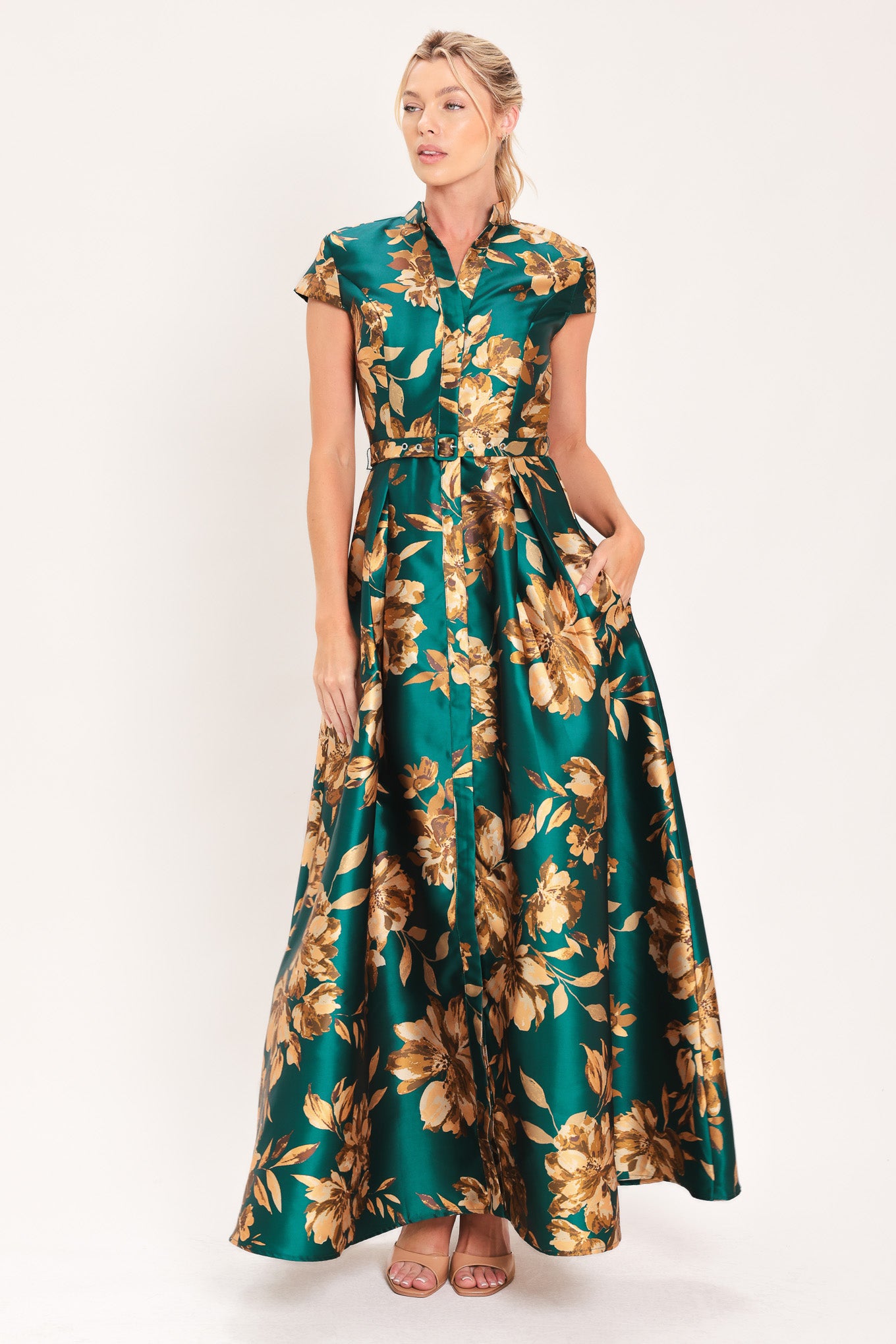 A woman modeling a maxi green satin dress with a gold floral print | Flying Tomato