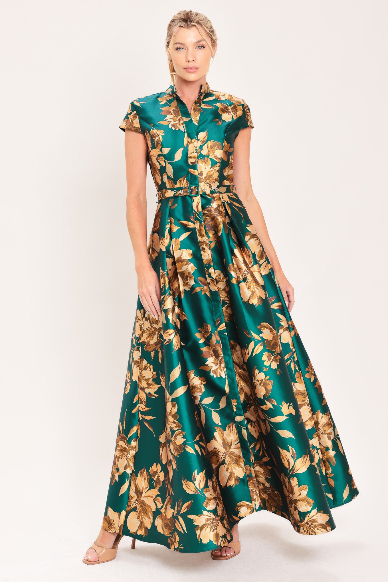A woman modeling a maxi green satin dress with a gold floral print | Flying Tomato