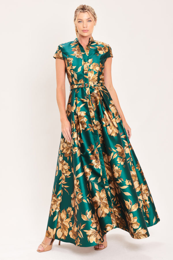 A woman modeling a maxi green satin dress with a gold floral print | Flying Tomato