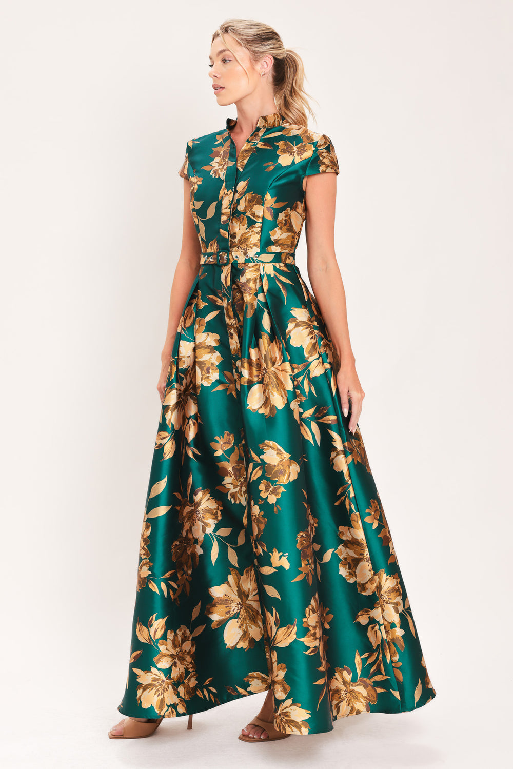 A woman modeling a maxi green satin dress with a gold floral print | Flying Tomato