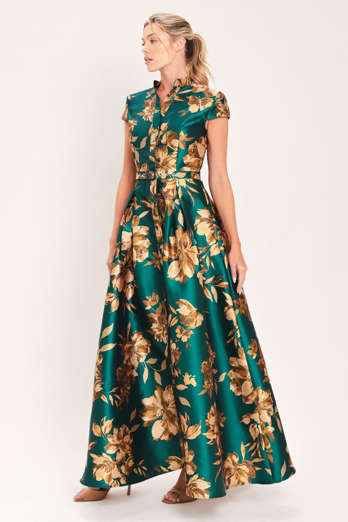 A woman modeling a maxi green satin dress with a gold floral print | Flying Tomato