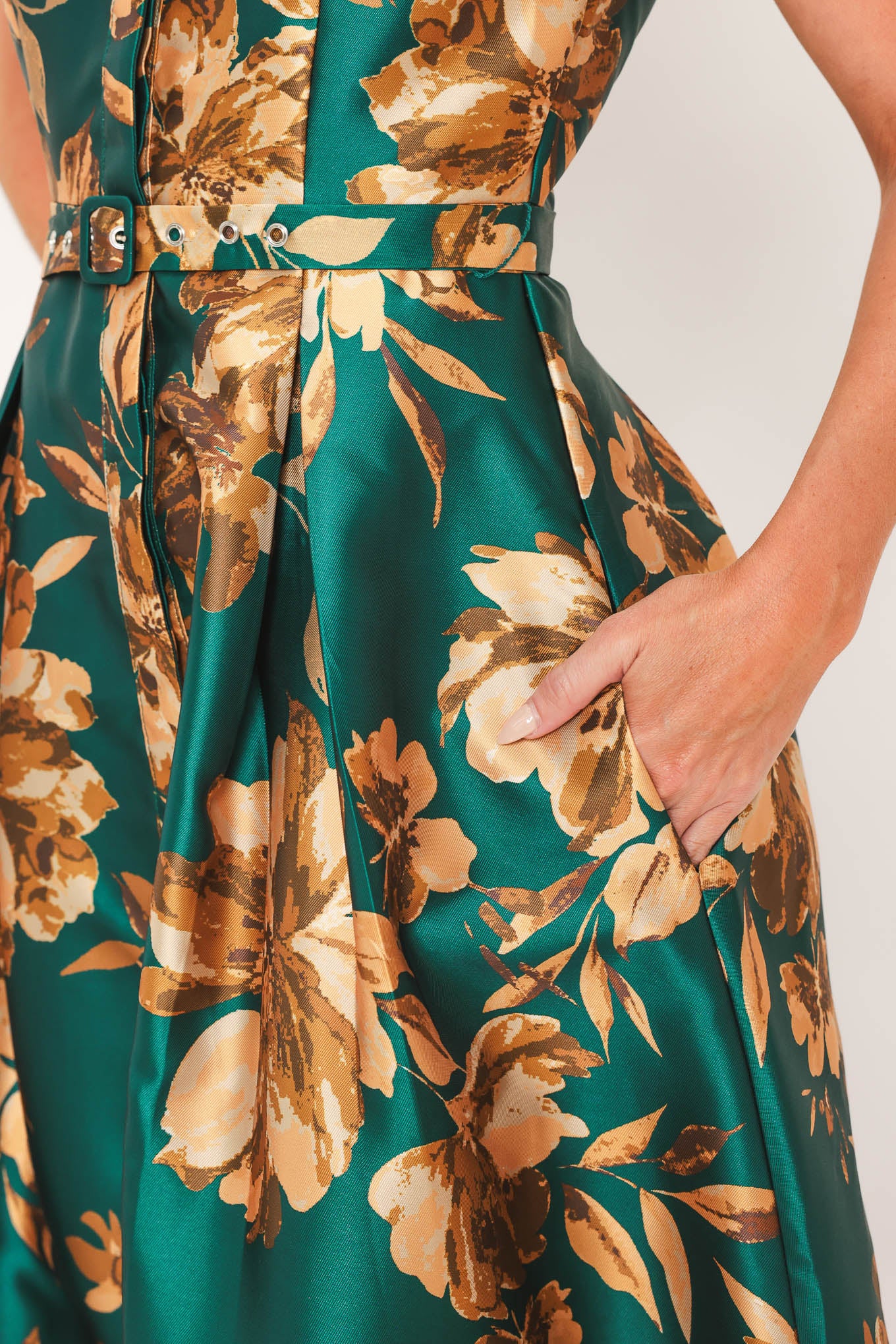 A woman modeling a maxi green satin dress with a gold floral print | Flying Tomato