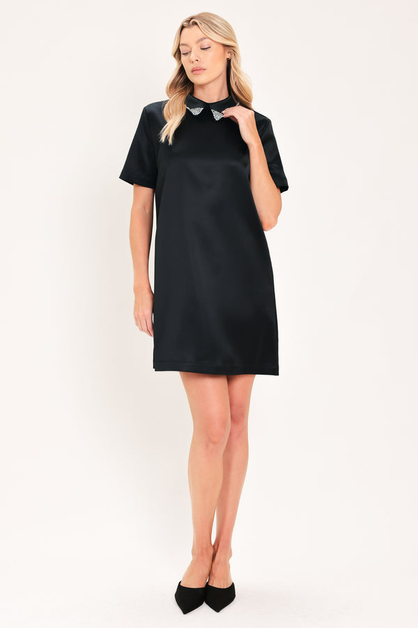 A woman modeling a black short-sleeve satin dress with a decorative silver collar | Flying Tomato