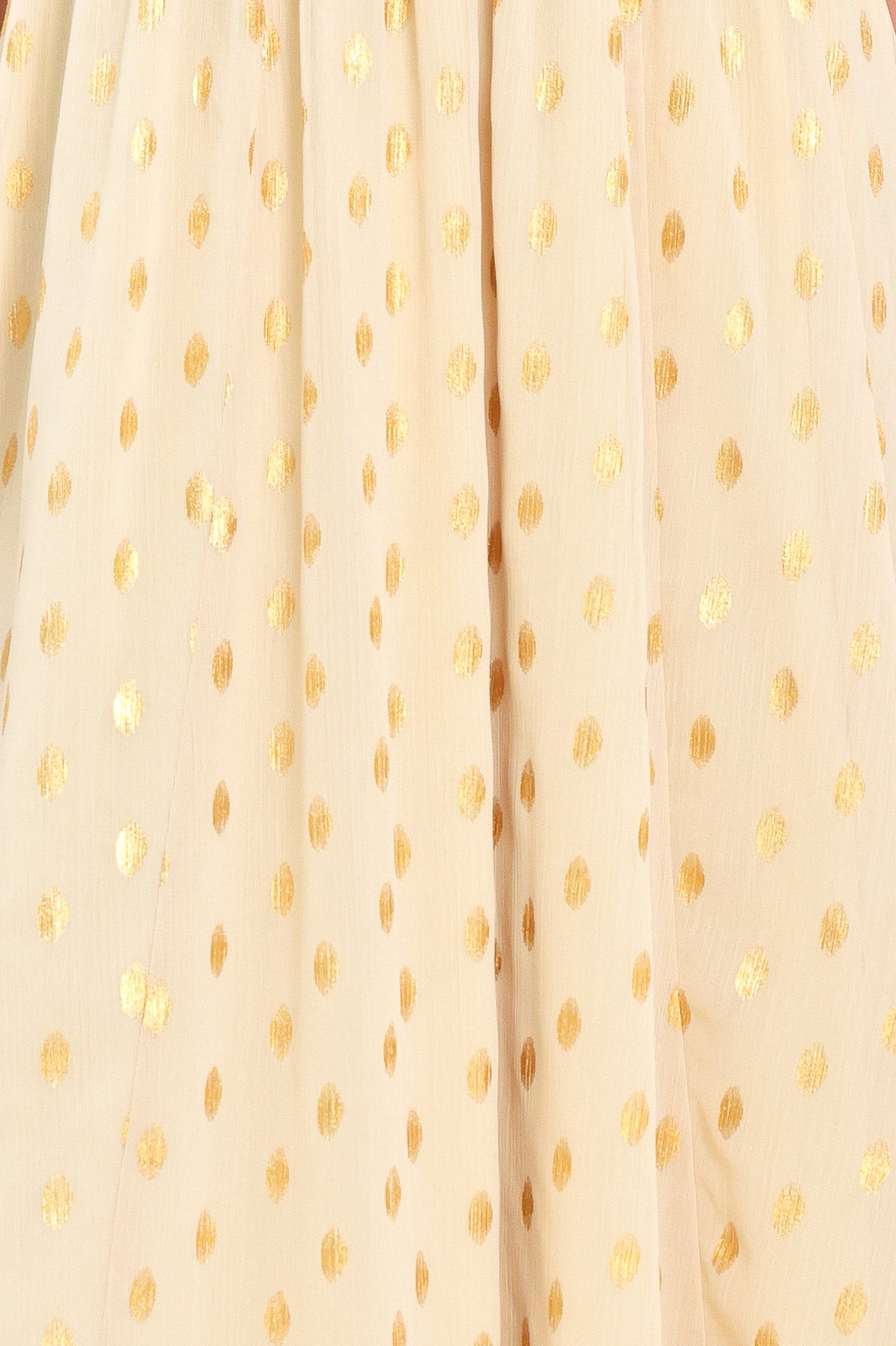 A woman modeling a light yellow midi dress with a small gold dotted pattern, featuring flutter sleeves and a V-neckline | Flying Tomato