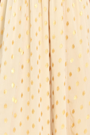 A woman modeling a light yellow midi dress with a small gold dotted pattern, featuring flutter sleeves and a V-neckline | Flying Tomato