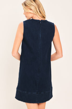 A woman wearing a sleeveless dark navy blue dress with a scalloped V-neckline | Flying Tomato