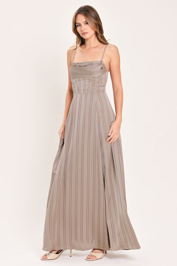 A woman modeling a floor-length taupe pleated maxi dress with spaghetti straps and a gathered sweetheart neckline | Flying Tomato