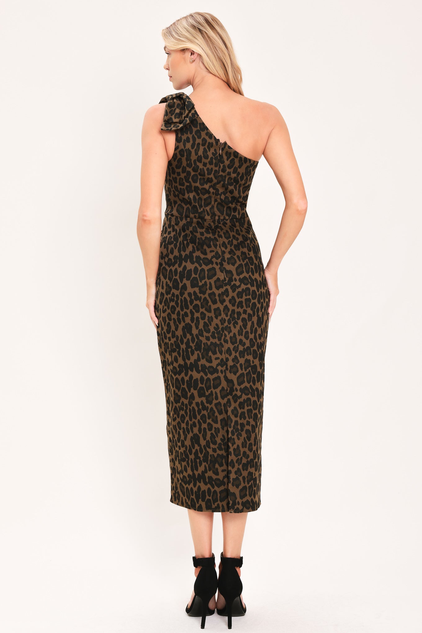 A woman modeling a one-shoulder leopard print midi dress with a oversize bow on the shoulder | Flying Tomato