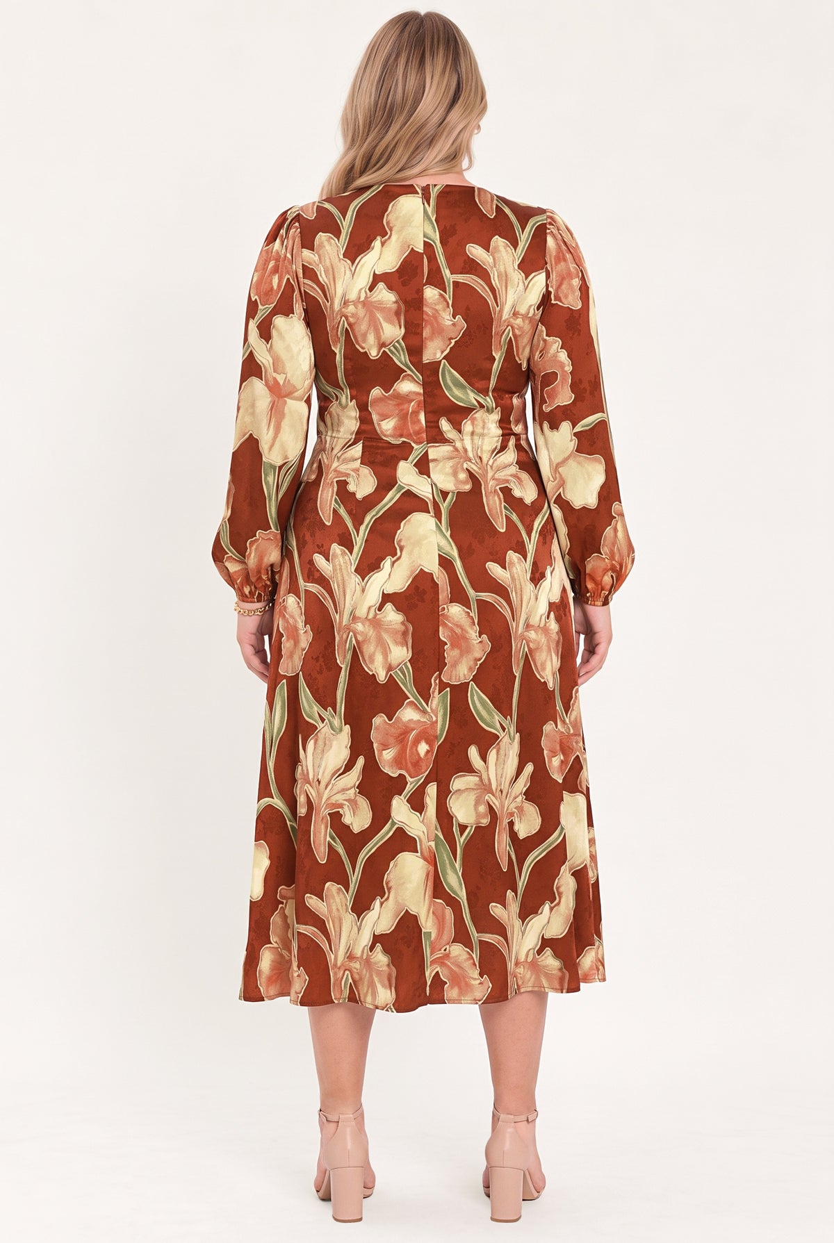 A woman modeling a long-sleeve midi wrap dress with a brown, beige, and green floral pattern | Flying Tomato