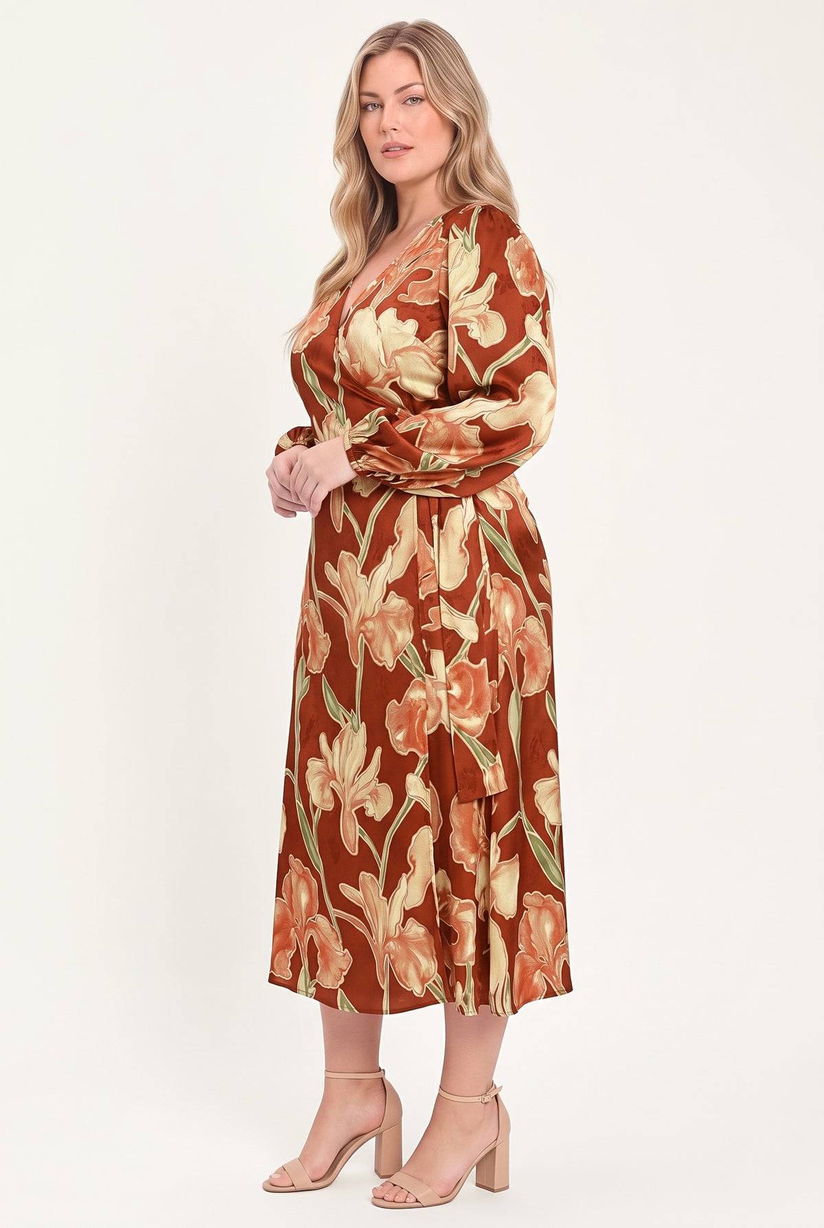 A woman modeling a long-sleeve midi wrap dress with a brown, beige, and green floral pattern | Flying Tomato