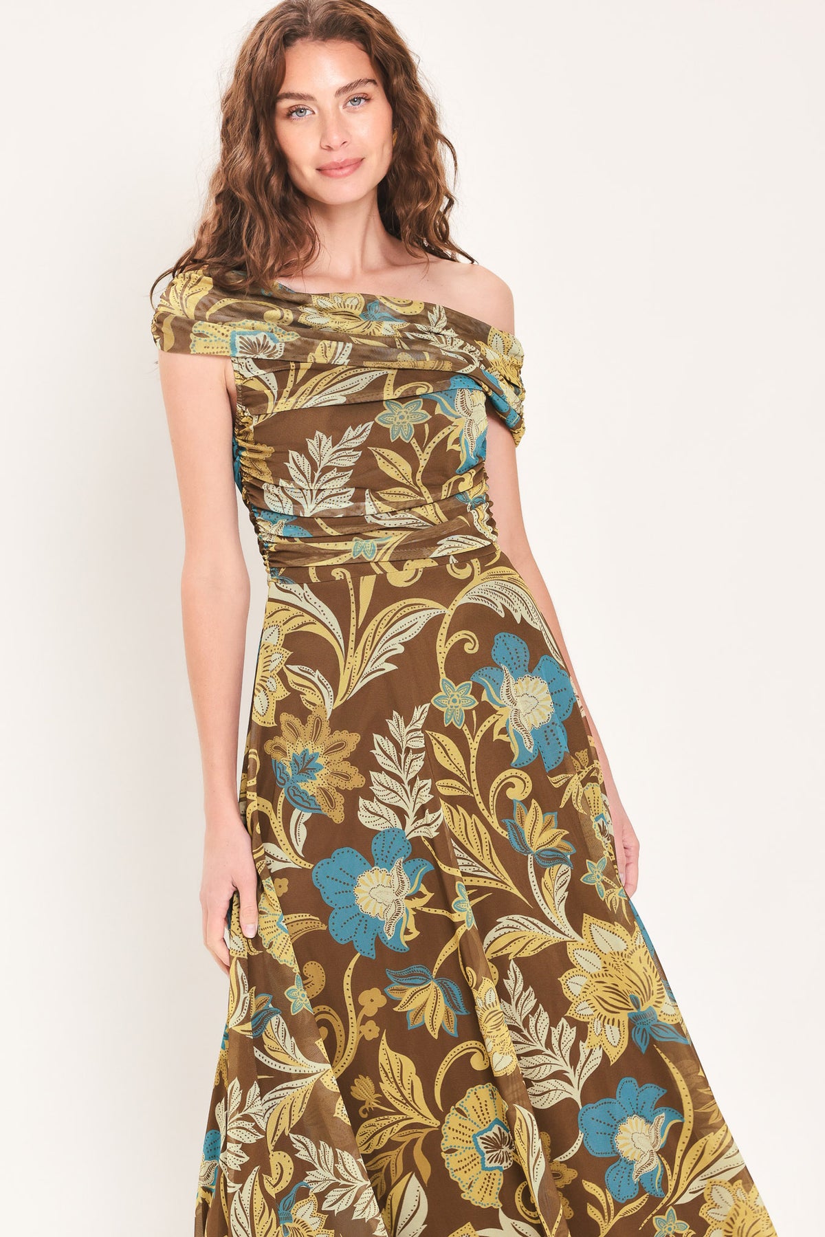 Woman wearing a brown off the shoulder mesh midi dress with teal and gold-tone floral and leaf pattern | Flying Tomato