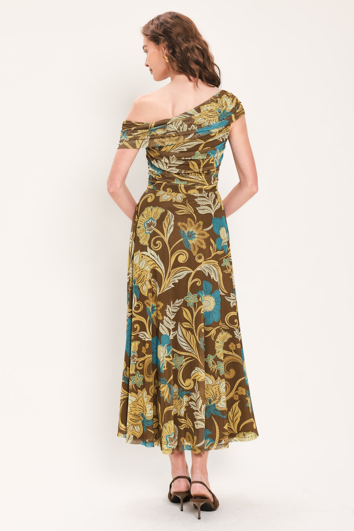 Woman wearing a brown off the shoulder mesh midi dress with teal and gold-tone floral and leaf pattern | Flying Tomato