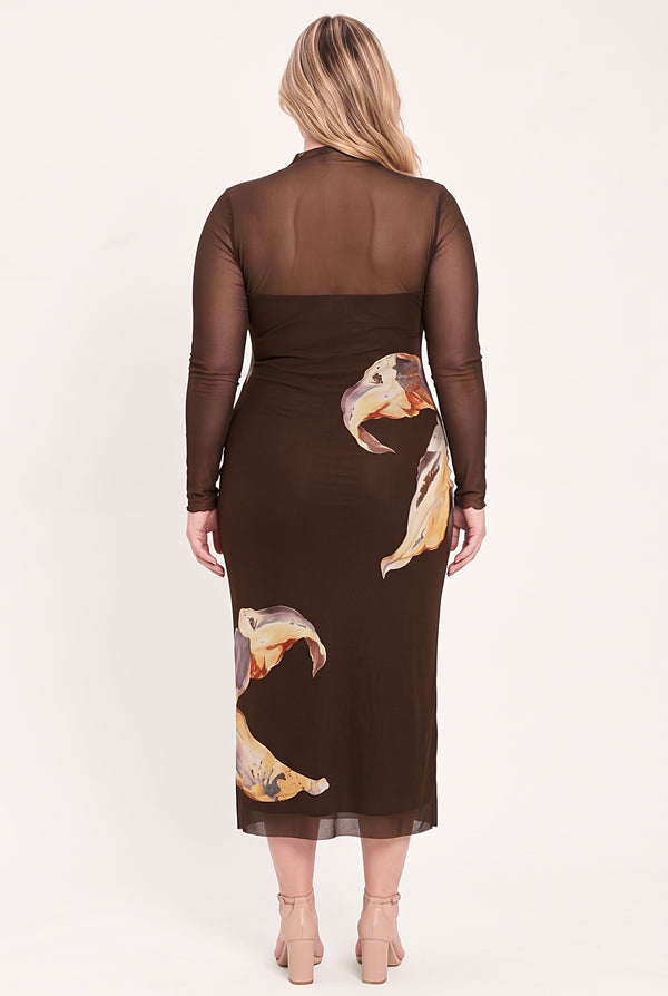 A woman modeling a brown long-sleeve midi dress with sheer mesh sleeves and a large yellow and beige floral print | Flying Tomato