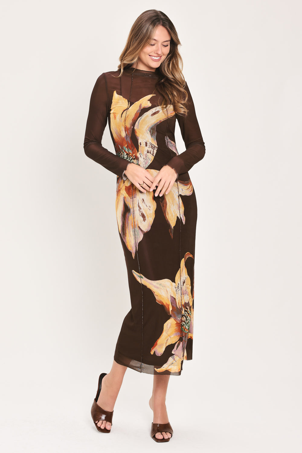 Woman wearing a brown midi mesh dress with a large floral print | Flying Tomato
