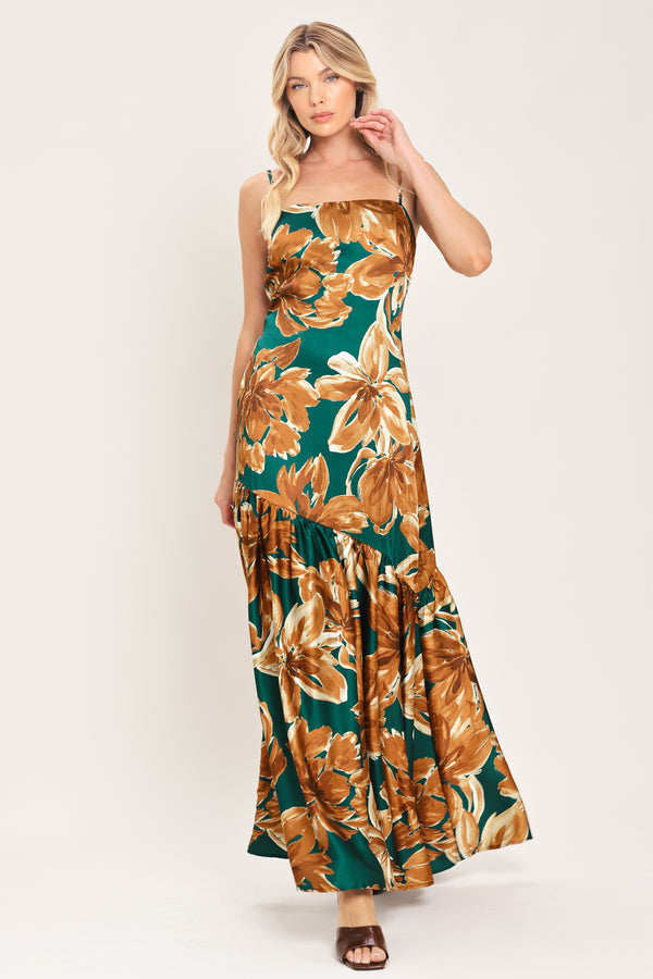 Woman wearing a spaghetti strap green maxi dress with brown floral pattern printed and asymmetrical tier from the thigh down | Flying Tomato