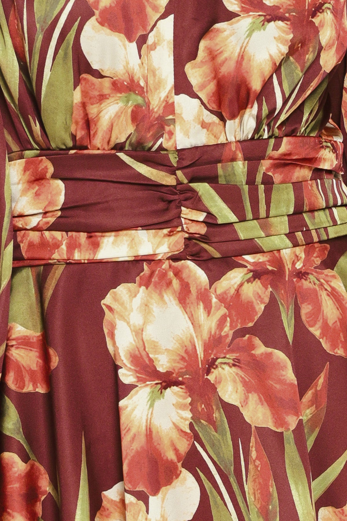 Woman wearing a burgundy long sleeve mini dress with a v neckline and ruched waist and floral and leaf print | Flying Tomato 